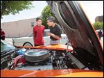  Dev Laungani, 12, and his father Raj Laungani, of Sylvania, check out a 1975 Corvette Stingray.