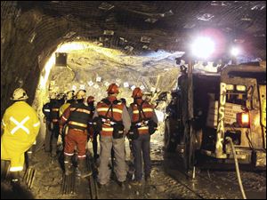 In this photo taken and released by PT Freeport Indonesia  Friday, the Indonesian unit of Arizona-based Freeport-McMoRan Copper & Gold Inc, rescuers gather inside a tunnel that collapsed on Tuesday morning as they continue their attempt to rescue trapped workers at Big Gossan mining area in Mimika, Papua province, Indonesia. 