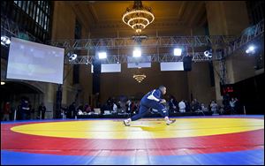U.S. freestyle wrestler Obe Blanc warms up for an exhibition wrestling match at Grand Central Terminal, Wednesday, May 15, 2013, in New York. 
