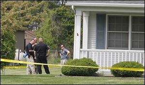 State and local authorities investigate a fatal shooting and home invasion on South River Road in Waterville Township.