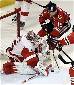 Red Wings goalie Jimmy Howard stops a shot from the Blackhawks' Jonathan Toews during the third period. Howard had 19 saves.