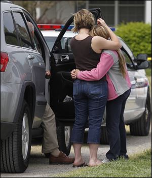 A cousin, left, and girlfriend of the victim watch.