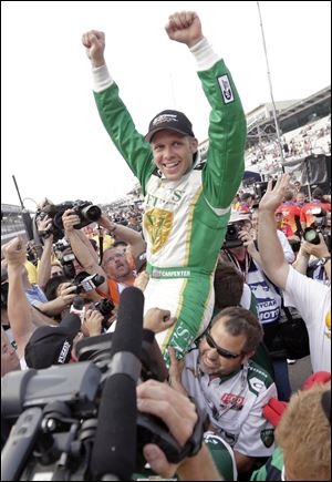 Ed Carpenter is lifted by his crew as he celebrates winning the pole position for the Indianapolis 500 auto race on the first day of qualifications today at Indianapolis Motor Speedway in Indianapolis.