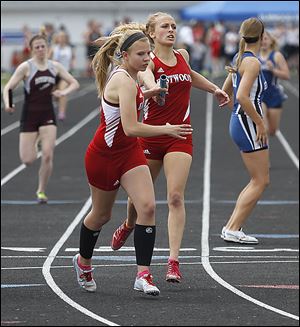 Eastwood’s Aricka LaVoy hands off to Kortni Montag as the Eagles won  the 1600-meter relay. LaVoy also won the long jump and helped win the 400 relay.