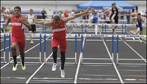 Eastwood’s Devin Snowden beats teammate Joey Salinas in a 300-meter hurdles heat. Snowden won the final and also captured the long jump and ran on two winning relay teams at the Northern Buckeye Conference meet.