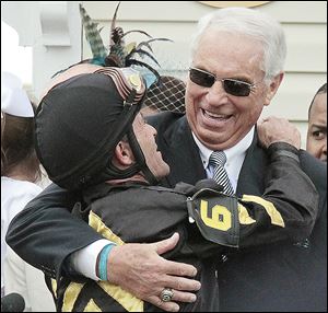 Jockey Gary Stevens, left, embraces trainer D. Wayne Lukas in the winner's circle after Oxbow gave Lukas his 14th win in a Triple Crown race. It was Stevens' first Triple Crown victory since 2001.