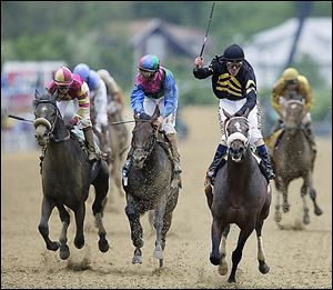 Jockey Gary Stevens celebrates aboard Oxbow after winning the 138th Preakness Stakes. Itsmyluckyday, center, finished second; and Mylute, left, was third.