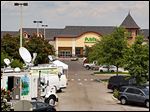  Satellite trucks line the parking lot outside the store where the highest Powerball jackpot ticket was sold. 