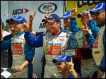  Ken Schrader, center, celebrates in Victory Lane after claiming the Menards 200 on Sunday afternoon at Toledo Speedway. It was the first ARCA start of the season for the longtime driver.