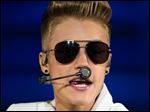  FILE - In this April 2, 2013 file picture Canadian singer Justin Bieber performs at O2 World in Hamburg, Germany. German officials say Justin Bieber will have to pay the bill for his monkey’s two month stay at a Munich animal shelter. A spokesman for Munich’s customs office says the cost of care, food and vet visits for Mally is several thousand euros (dollars). That’s, of course, what you might call “chimp change” for the global superstar. Customs spokesman Thomas Meister says Bieber has until midnight Friday May 17, 2013  to claim the monkey seized by authorities March 28 when the singer failed to produce its papers after landing in Munich on tour. Bieber’s management company has asked the shelter to place the 20-week-old monkey in a zoo but hasn’t talked with customs. If not claimed, Mally becomes German government property and will likely go to a zoo in any case.  (AP Photo/dpa, Sven Hoppe,File)