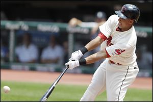 Cleveland Indians' Michael Brantley hits an RBI-single off Seattle Mariners starting pitcher Felix Hernandez in the first inning of the MLB American League baseball game.