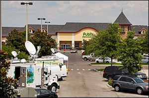 Satellite trucks line the parking lot outside the store where the highest Powerball jackpot ticket was sold. 