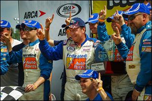 Ken Schrader, center, celebrates in Victory Lane after claiming the Menards 200 on Sunday afternoon at Toledo Speedway. It was the first ARCA start of the season for the longtime driver.