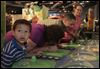  Jorge Aguilar, 6, left, his grandmother Nedra Pike, and parents Ryan Pike and Whitney Mekus react to Sniff Sniff U Stink, an interactive exhibit at Grossology. Each member of the Defiance family took a whiff of something from the human body at the Imagination Station in downtown Toledo on Sunday. 