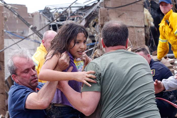 A-child-is-pulled-from-the-rubble-of-the-Plaz