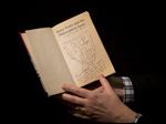  Sotheby's director of the department of printed books and manuscripts Philip Errington poses for photographers with a first edition copy of the first Harry Potter book 