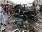  Civilians gather at the scene of a car bomb attack in Kamaliyah neighborhood, a predominantly Shiite area of eastern Baghdad, Iraq, today.