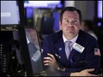  FILE - In this Tuesday, May 7, 2013, photo, specialist Charles Boeddinghaus works at his post on the floor of the New York Stock Exchange. Evidence of a steady economic recovery in the U.S. helped push world stock markets higher Monday.  (AP Photo/Richard Drew)