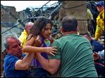  A child is pulled from the rubble of the Plaza Towers Elementary School in Moore, Okla., and passed along to rescuers. Officials say an estimated 20 to 30 schoolchildren were missing and feared dead. Rescuers were still combing through the rubble.