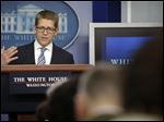  White House Press Secretary Jay Carney gestures as he speaks during his daily news briefing at the White House in Washington.