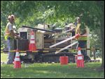  Workers prepare to take a soil sample at the former Whirlpool Park as part of an examination of the property for contamination at the park near Clyde, Ohio.