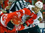  Detroit defenseman Kyle Quincey, left, and Chicago left wing Bryan Bickell mix it up in the first period.