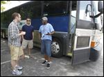  From left: Lifeline volunteer Bryce Roberts, intern Rob Anderson and volunteer Gary Bond converse prior to boarding this bus that will take them from New Harvest Church in Oregon to Monroe, Ohio, where soccer players will kick a soccer ball to Toledo as part of a charity fundraiser.