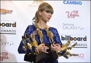 Taylor Swift poses backstage with her awards at the Billboard Music Awards at the MGM Grand Garden Arena on Sunday in Las Vegas.