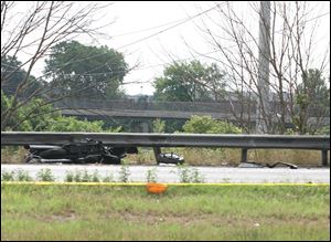 A motorcycle was wedged between the guardrail and the berm of I-475 in a 2011 crash with other vehicles. 