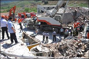 Rescuers work at the site where a blast ripped through an explosives manufacturing plant in Caofan Township of Zhangqiu City, east China's Shandong Province, today.