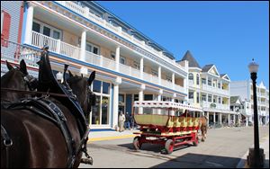 Mackinac Island’s newest hotel, the Bicycle Street Inn& Suites on Main Street, is opposite Shepler’s dock. The resort island between lakes Huron and Michigan that bans cars and yet draws close to a million visitors each year is facing key decisions on what development to allow to accommodate the tourist business that keeps it alive. 