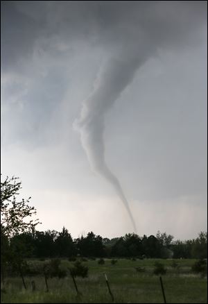 A tornado touches down southwest of Wichita, Kan. near the town of Viola on Sunday. The tornado was part of a line of storms that past through the central plains on Sunday.