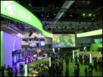  FILE - In this June 5, 2012 file photo, show attendees walk past Microsoft XBox booth at E3 2012 in Los Angeles. With the next Xbox expected to finally be revealed Tuesday, May 21, 2013, at Microsoft's headquarters in Redmond, Wash., anticipation for what the company is planning for the next iteration of its gaming console is higher than Master Chief's last spaceship. (AP Photo/Damian Dovarganes, File)