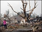  A resident surveys the damage after the tornado hit the area near 149th and Drexel on Monday, May 20, 2013 in Oklahoma City, Okla. (AP Photo/ The Oklahoman, Chris Landsberger)