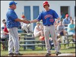  St. Francis coach Tim Gerken greets Michael Wagner at third base. Wagner, a senior catcher, is hitting .377 with 13 RBIs.