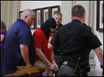  A hooded Michael Aaron Fay leaves Juvenile Court after appearing before Judge Michael A. Borer in connection to aggravated murder at the Putnam County Courthouse in Ottawa.