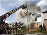  Firefighters from the Toledo Fire Department battle a fully involved structure fire Oak Street. The fire is being investigated as a possible arson.