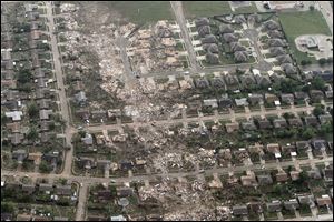 This aerial photo shows the remains of homes hit by a massive tornado in Moore, Okla., Monday.