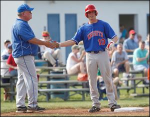 St. Francis coach Tim Gerken greets Michael Wagner at third base. Wagner, a senior catcher, is hitting .377 with 13 RBIs.