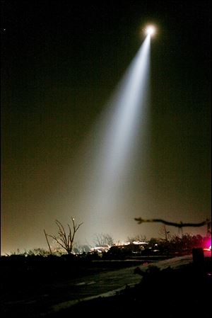 Rescue workers combed through the rubble Monday night and Tuesday morning using spotlights from helicopters.