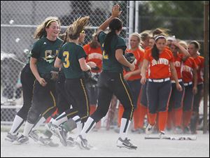 Clay players run off the field in celebration after defeating Southview in a Division I district semifinal softball game at Rolf Park in Maumee. 
