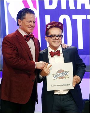 Cleveland Cavaliers owner Dan Gilbert poses with his son Nick Gilbert after winning the NBA basketball draft lottery today in New York.