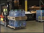  Marco's employee Jason Braden loads supplies onto a truck to depart for Oklahoma.