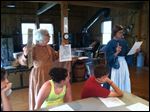  Volunteers of Sylvania's Historical Village, Connie Ryan, left, and Sarah Groves, right, hold up posters and advertisements published in the 1850's by slave owners asking for the prompt return of a runaway slave. Fifth grade students of Sylvan Elementary had an all day field trip at the village about the underground railroad. 