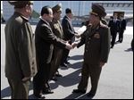  High-ranking North Korean party and military official Choe Ryong Hae, front right, shakes hands with officials as he departs for China as a special envoy of North Korean leader Kim Jong Un, at Pyongyang airport, North Korea today.