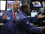  In this Aug. 11, 2010 photo, specialist John Urbanowicz, left, talks with a colleague on the floor of the New York Stock Exchange. Stocks are opening Wednesday, May 22, 2013, slightly higher as investors watch for the latest moves from the Federal Reserve.  (AP Photo/Richard Drew)