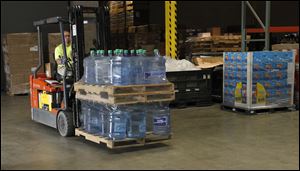 Marco's employee Jason Braden loads supplies onto a truck to depart for Oklahoma.