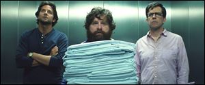 Bradley Cooper as Phil, left, Zach Galifianakis as Alan, center, and Ed Hlems as Stu in a scene from 
