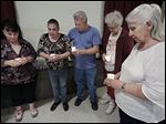  From left, Risa Smith, Beth Stump, Terry Stump,  Nevaeh Buchanan's great-aunt Diana Lawson, and Nevaeh's grandmother Sherry Buchanan participate in a candlelight vigil organized by Justice For Nevaeh.  The vigil in Monroe on Wednesday marked four years since Nevaeh Buchanan was abducted and later found murdered.