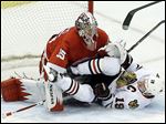  Chicago Blackhawks center Jonathan Toews crashes into Detroit goalie Jimmy Howard during the second period. Howard kept everything out of the night on Thursday night to give the Wings a commanding lead as the series heads back to Chicago.